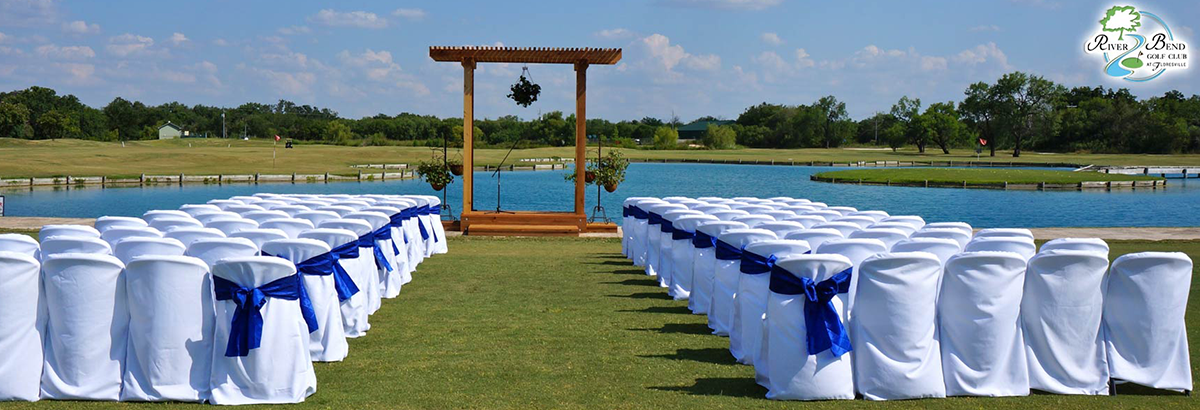 wedding aisle with blue ribbons on chairs